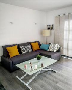 a living room with a couch and a coffee table at SUNNY CORNER Apartment in Puerto del Carmen