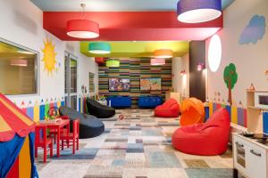 a childrens playroom with colorful chairs and tables at Akces Medical Fit & Spa in Dźwirzyno