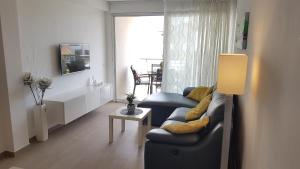 a living room with a couch and a table at Luna Apartment in Poreč