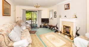 a living room with a couch and a fireplace at Luxury House in Warsash. in Warsash