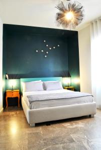 a bedroom with a large bed with a green wall at moon's fault - tutta colpa della luna in Pozzuoli