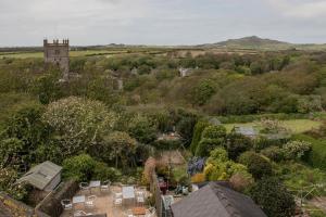 an aerial view of a village with trees and a tower at Glendower B&B in St. Davids
