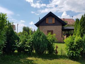 a brick house with a window in a yard at Cottage Plavi Lav Potok in Potok