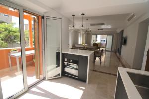 a kitchen with a table and a dining room at Sotogrande - SotoLUX in Sotogrande