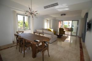a living room with a table and chairs and a couch at Sotogrande - SotoLUX in Sotogrande