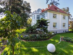 an egg sits in the grass in front of a house at Villa Testa in Sopot