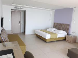 Postel nebo postele na pokoji v ubytování El Greco Hotel