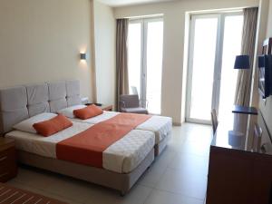 Postel nebo postele na pokoji v ubytování El Greco Hotel