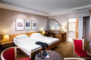 a hotel room with a bed and a table and chairs at City Hotel Biel Bienne Free Parking in Biel