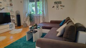 a living room with a couch and a television at Apartment GoodMood in Split