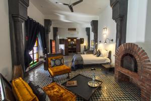 a living room with a bed and a fireplace at Riad Laaroussa in Fez