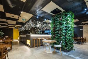 a room with a large green plant in the middle of the room at Ibis Praha Wenceslas Square in Prague