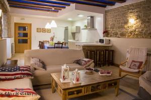 a living room with a couch and a table at Casa Rural Villazón II - A 16 km de Pamplona in Obanos +15 photos