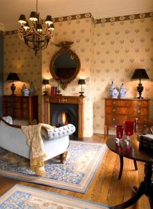 
a living room filled with furniture and a fireplace at Brugsche Suites - Luxury Guesthouse in Bruges
