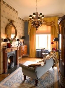 a living room with a couch and a fireplace at Brugsche Suites - Luxury Guesthouse in Bruges