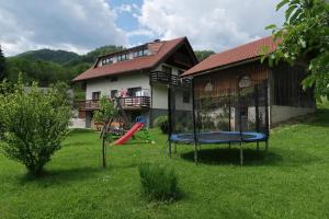 a yard with a playground and a house at Rooms Zupančič in Bohinjska Bela