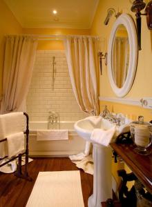 a bathroom with a sink and a tub at Brugsche Suites - Luxury Guesthouse in Bruges