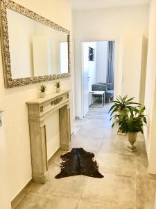 a living room with a fireplace and a mirror at Ferienwohnung Roxana - am Bodensee in Friedrichshafen +19 photos