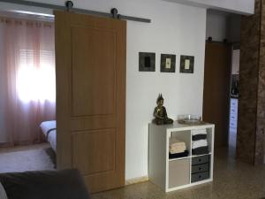 a room with a wooden door and a small cabinet at Apartman Dénia in Denia