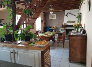 a kitchen with a table with potted plants on it at Chambres d'hôtes Châtres-Sur-Cher in Châtres-sur-Cher