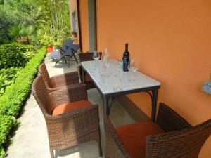 a table and chairs with wine glasses on a patio at Apartment Magnolia in Rijeka