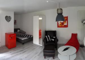 a living room with a couch and a table at Arthouse Apartment 2 in Bad Vilbel
