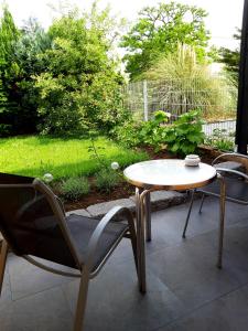 a table and a chair and a table and a table at Arthouse Apartment 2 in Bad Vilbel