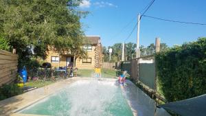 a backyard with a pool with a water fountain at La Porteña in Gualeguaychú
