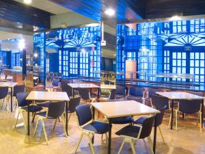 a restaurant with wooden tables and chairs and blue walls at Magic Cristal Park in Benidorm