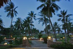 a view of a resort with palm trees at night at The Lawford in Malindi