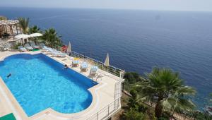 a swimming pool with the ocean in the background at Blue Lagoon Village in Gazipasa