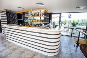 a bar in a restaurant with a view at Garden Palace in Zugdidi