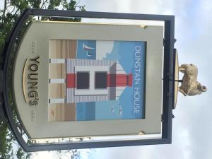 a sign with a teddy bear on top of it at Dunstan House in Burnham on Sea