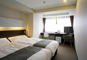 Postel nebo postele na pokoji v ubytování KOKO HOTEL Numazu Inter + 32 fotografií