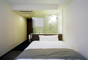 En eller flere senge i et værelse på KOKO HOTEL Numazu Inter