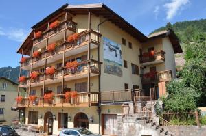 a building with flower boxes on the balconies at Albergo Dolomiti in Capriana