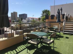 a group of tables and chairs on a balcony at Home Inn Self-Catering in Windhoek