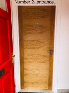 a wooden door with the number entrance at Whiteley’s Cottages studio in Dumbarton