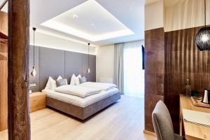 Łóżko lub łóżka w pokoju w obiekcie Hotel Gerl