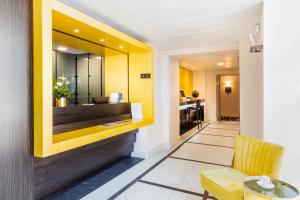a lobby of a hotel with a chair and a desk at Best Western Hôtel Journel Antibes Juan-les-Pins in Antibes