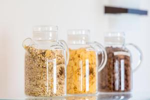 three glass jars filled with granola on a counter at Best Western Hôtel Journel Antibes Juan-les-Pins in Antibes