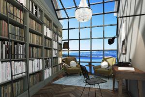 a library with a large window and two chairs and books at DESIGN hotel VERBENICUM in Vrbnik