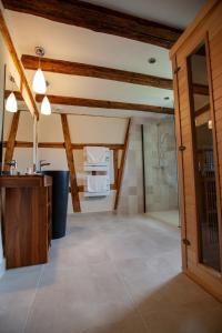 a bathroom with a shower and a glass door at Le gîte des Histoires in Kientzheim