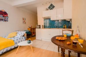 a kitchen and a living room with a table at Baionako Apartamentua in Bayonne