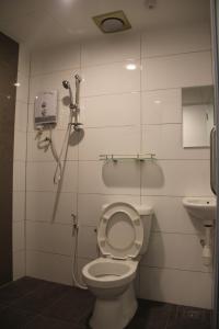 a bathroom with a shower and a toilet and a sink at Amanjaya Hotel in Sungai Petani