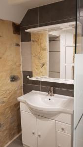 a bathroom with a white sink and a mirror at Gite de la Haie in Apremont +42 photos