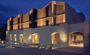 a building with a lit up facade at night at Contessina Hotel in Tsilivi