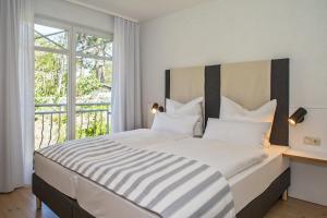 Säng eller sängar i ett rum på Upstalsboom Apartments Strandidyll