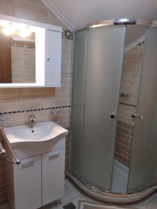 a bathroom with a shower and a sink at Casa del centro in Kardámyla +10 photos