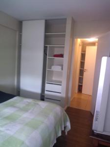 a bedroom with a bed and an open closet at Cerrito 1326 Apartamento in Rosario